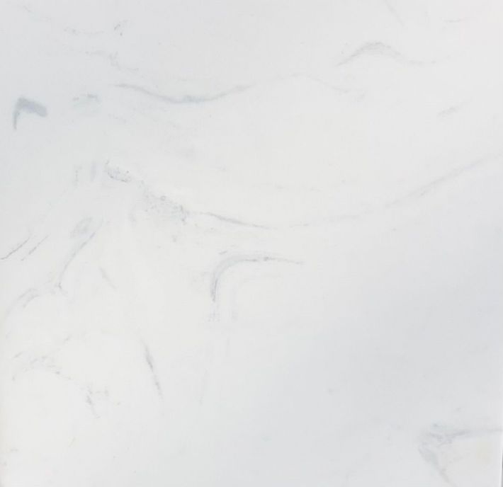 A texture of white marble stone with subtle grey veining running diagonally across the surface.