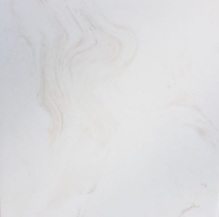 A close-up, top-down view of a textured dark gray stone surface with subtle white and green mineral veining throughout.