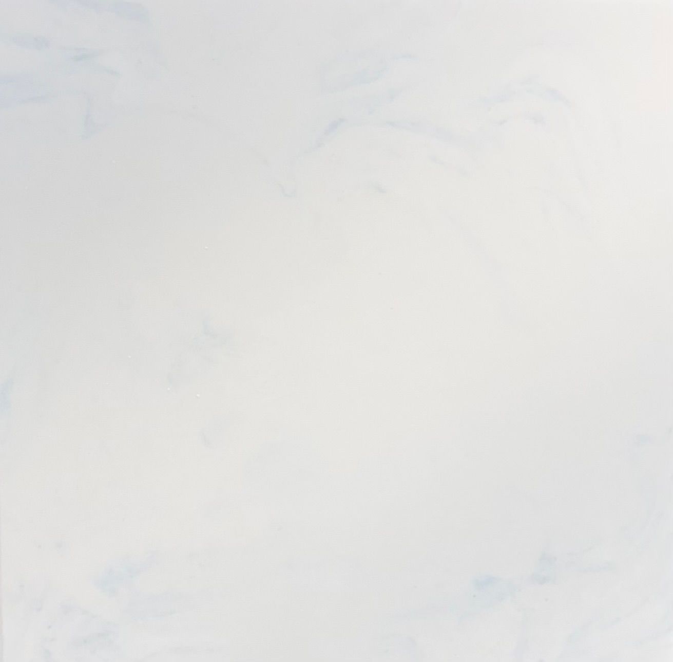 A texture of white marble stone with subtle grey veining running diagonally across the surface.