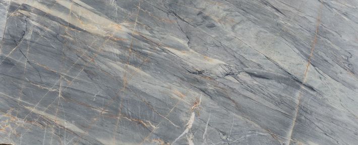 White marble surface with delicate, flowing gray veins across the texture.