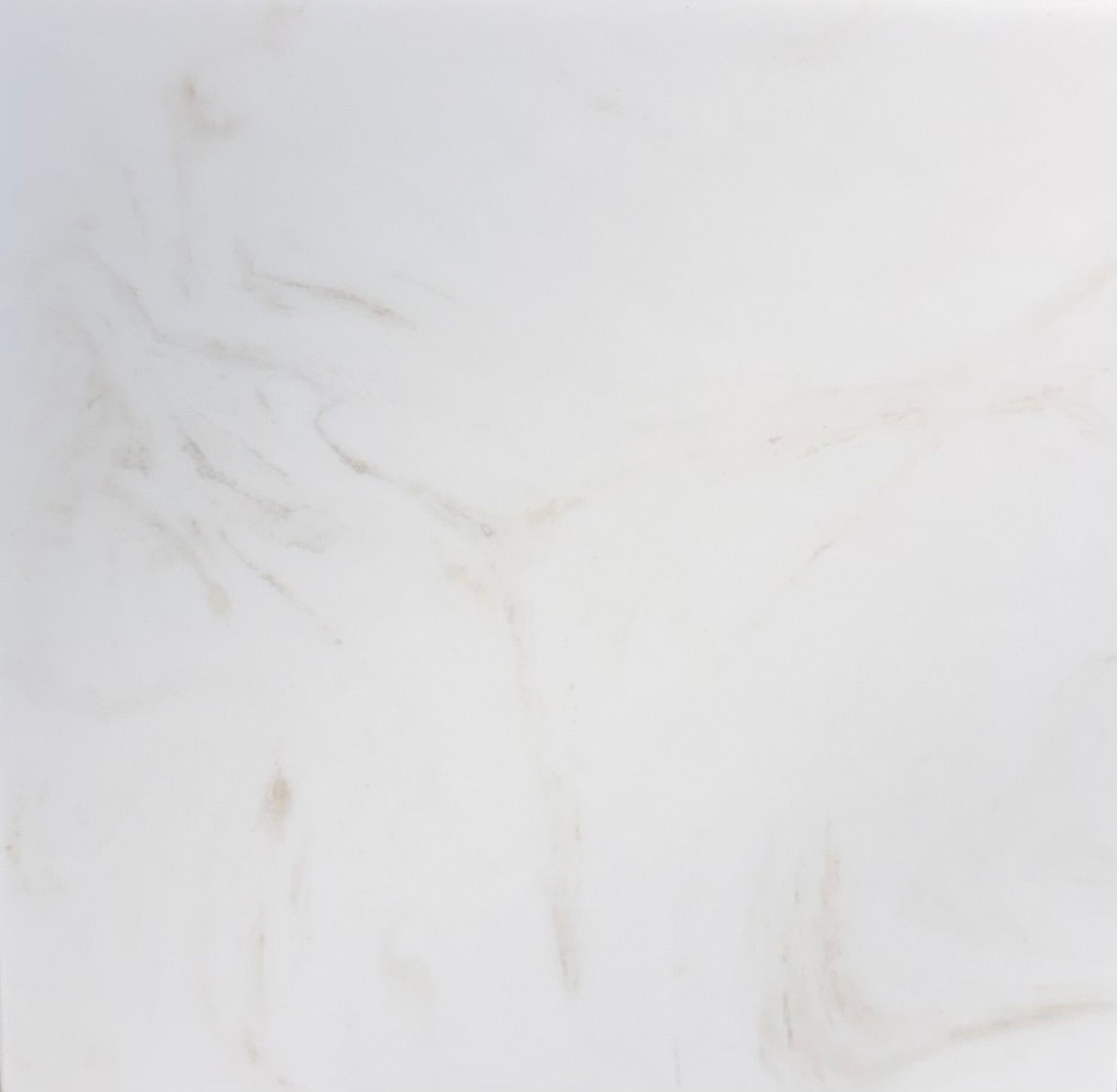 A texture of white marble stone with subtle grey veining running diagonally across the surface.