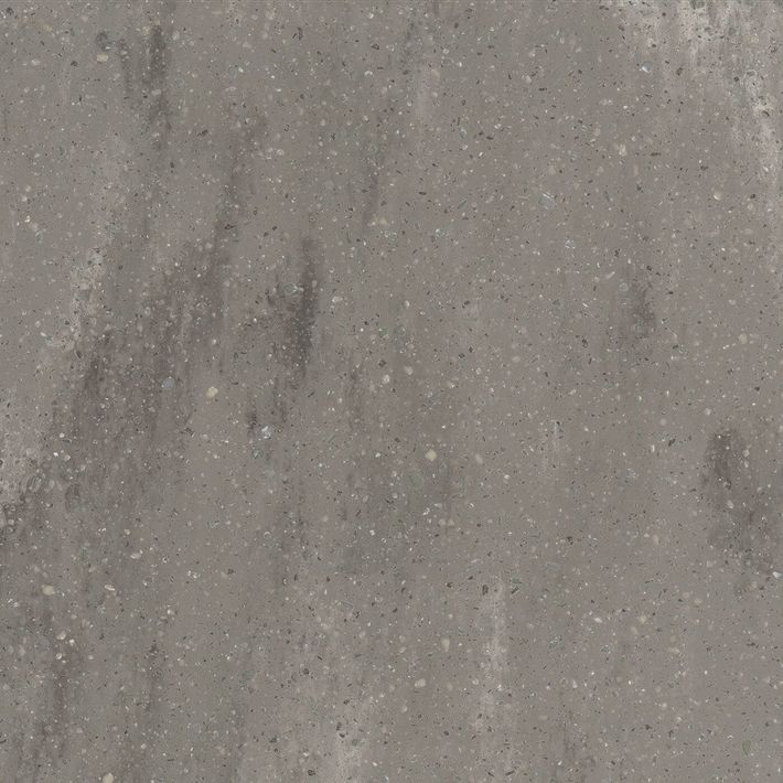 A close-up, top-down view of a textured dark gray stone surface with subtle white and green mineral veining throughout.