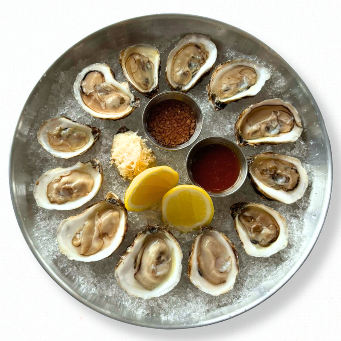 East Coast Oysters with Horseradish, Hot Sauce, Apple & Prosecco Mignonette on a white tablecloth-covered table. 