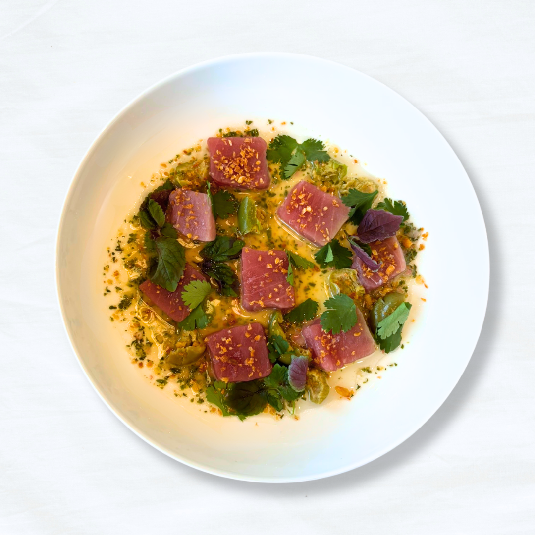 Yellowfin Tuna on a white tablecloth-covered table. 