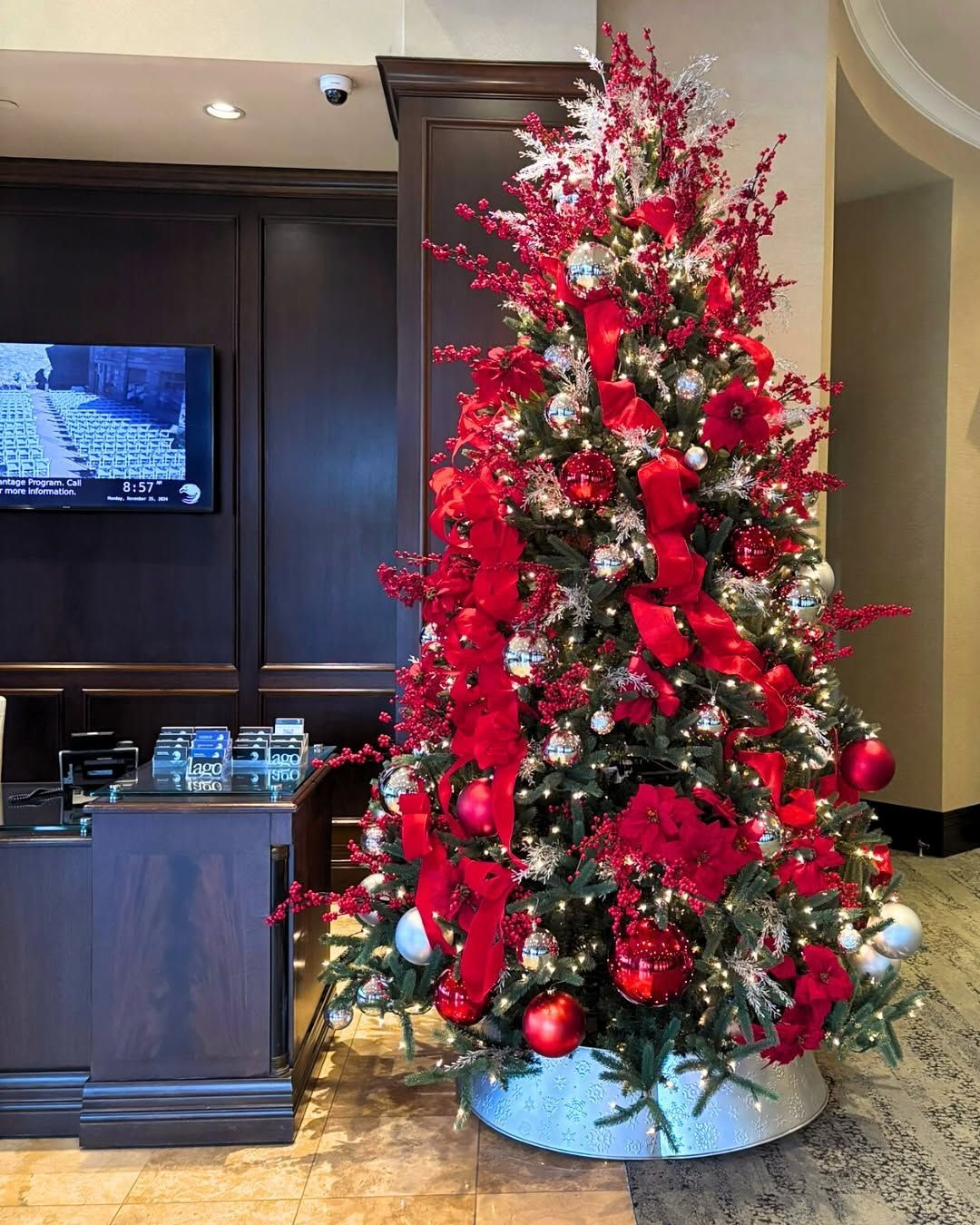 A Christmas tree decorated with red and silver decorations. 