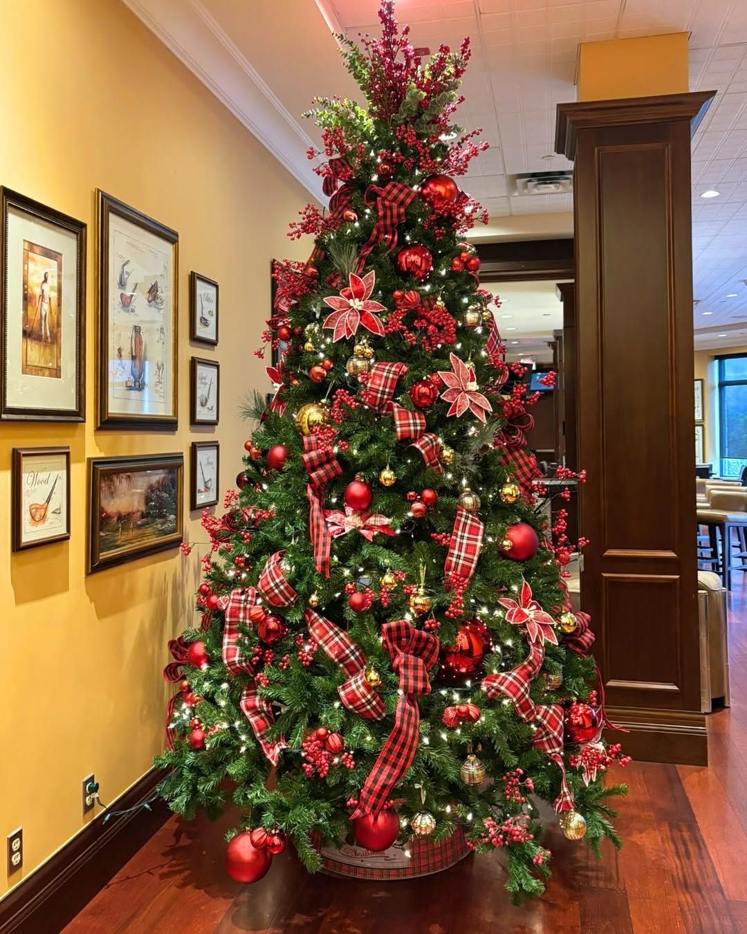 A large Christmas tree decorated in gold and red plaid. 