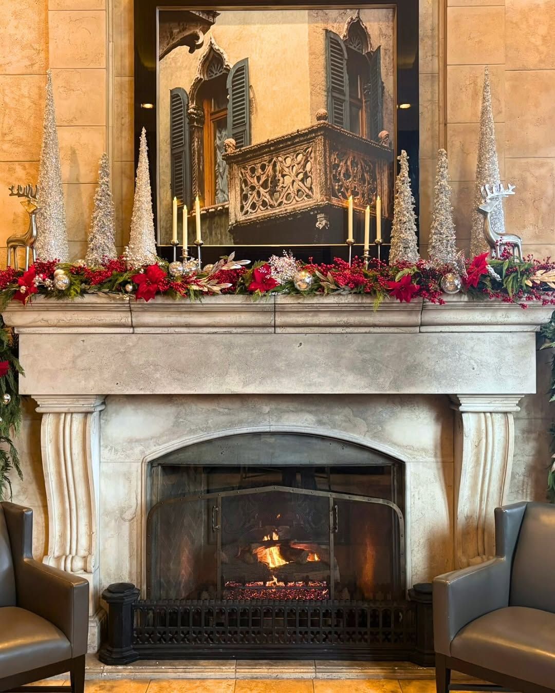 Fireplace decorated with red and silver Christmas decorations.
