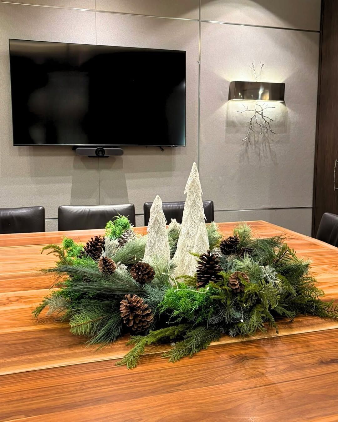 The Dufferin Room meeting table with Christmas greens and small white decorative trees.