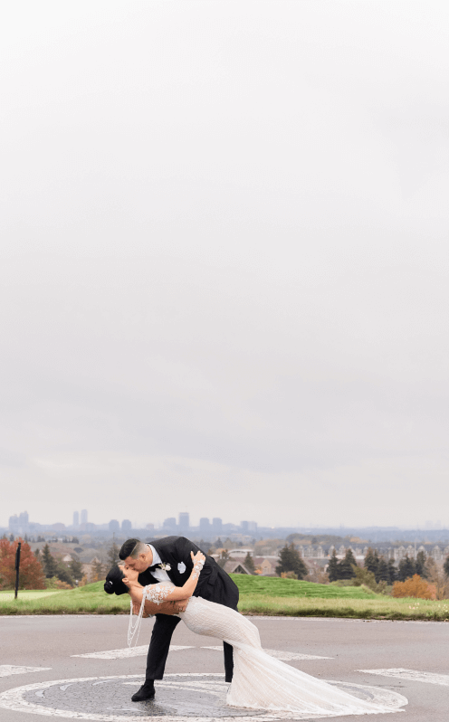 Married couple kissing on helipad