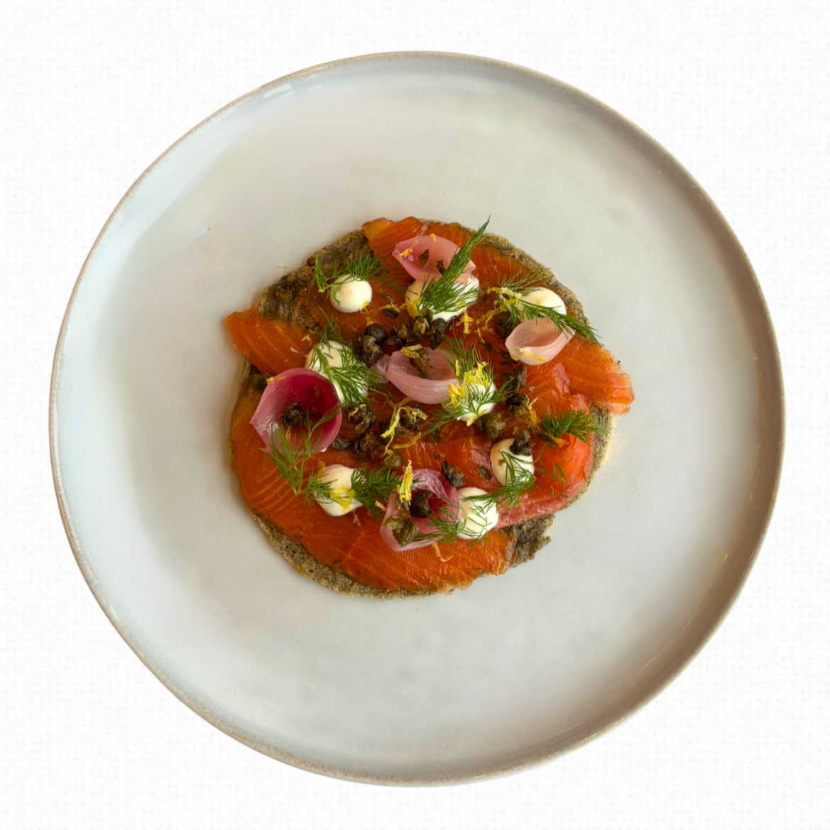 Trout Gravlax on a white tablecloth-covered table. 