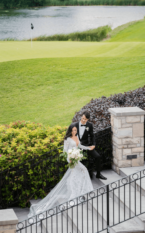 Married couple walking up large stone steps