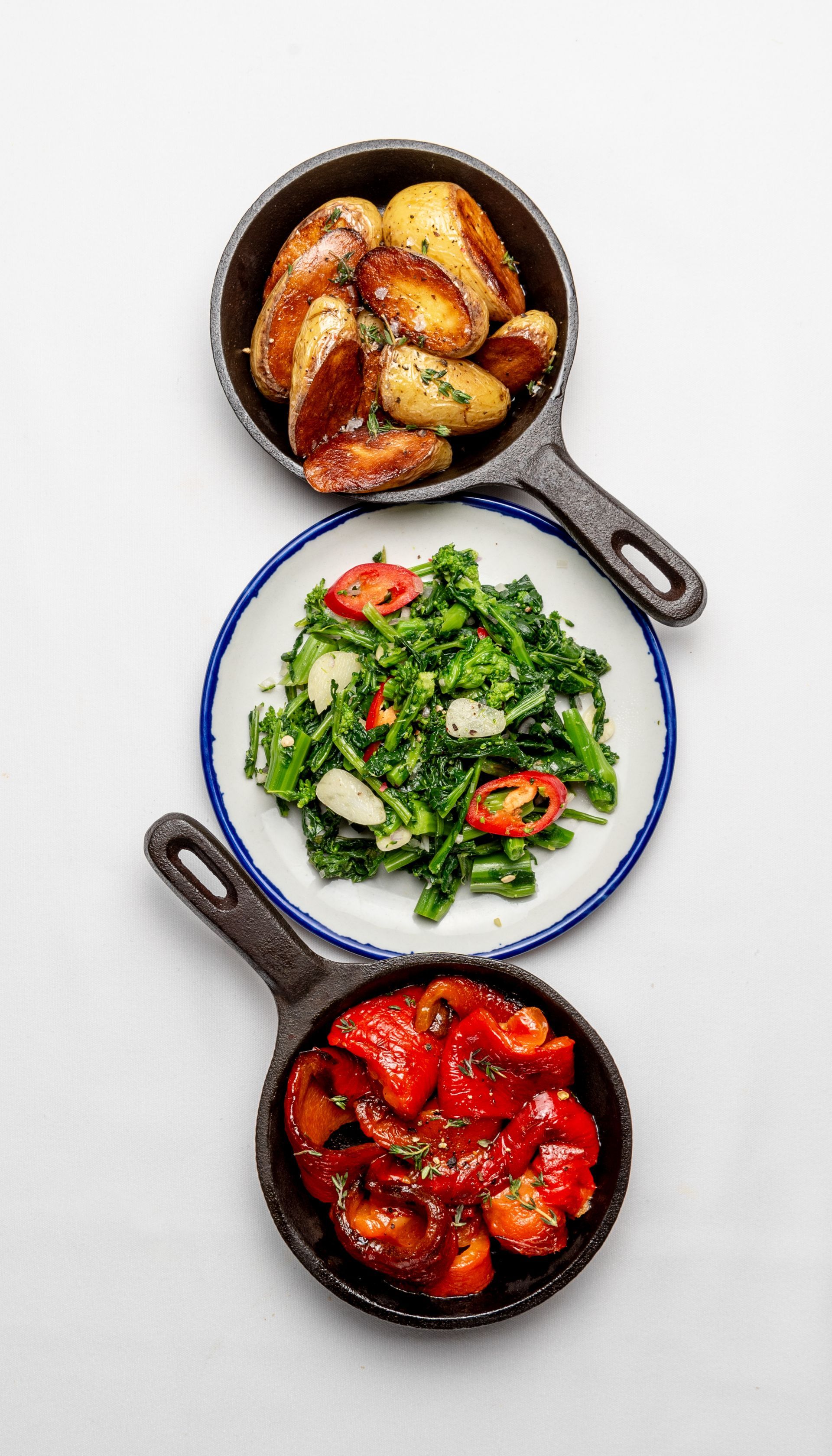 A plates of four vegetables on a white background .