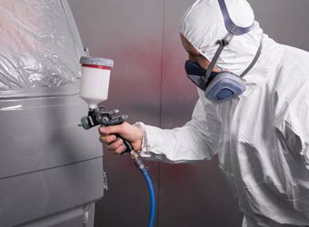 Body Work — Man Spraying A Car Paint in Redlands, CA