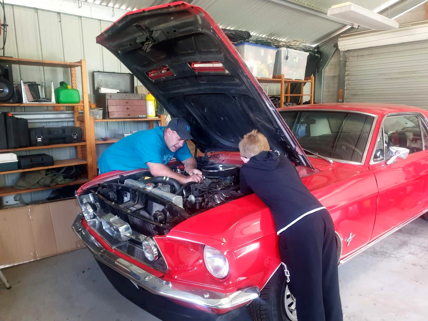 Two People Working on A Red Classic Car with The Hood Open — Autoplus Picton in Picton, NSW