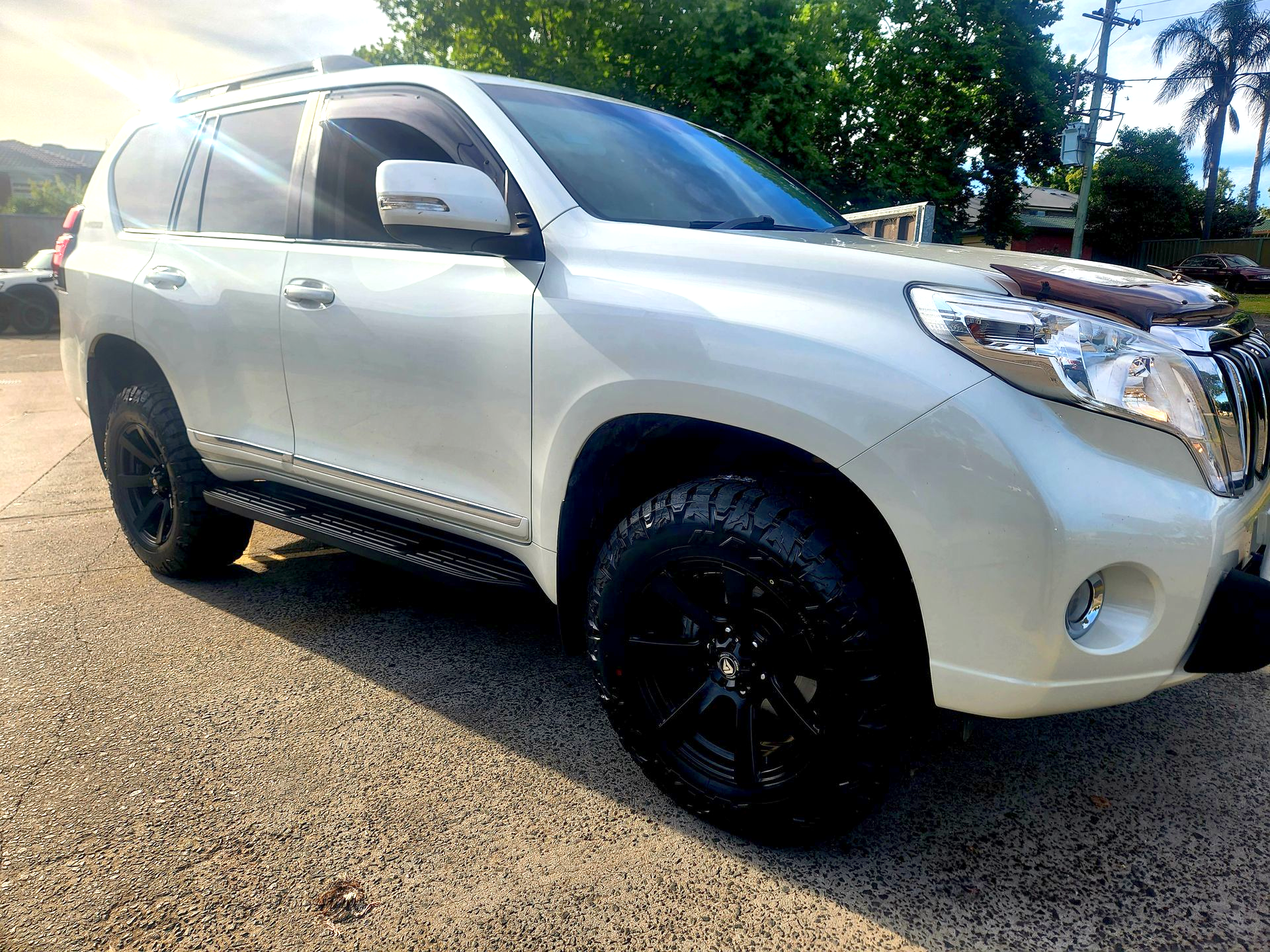 White Toyota Land Cruiser Prado SUV with Black Wheels Parked on Pavement — Autoplus Picton in Picton, NSW