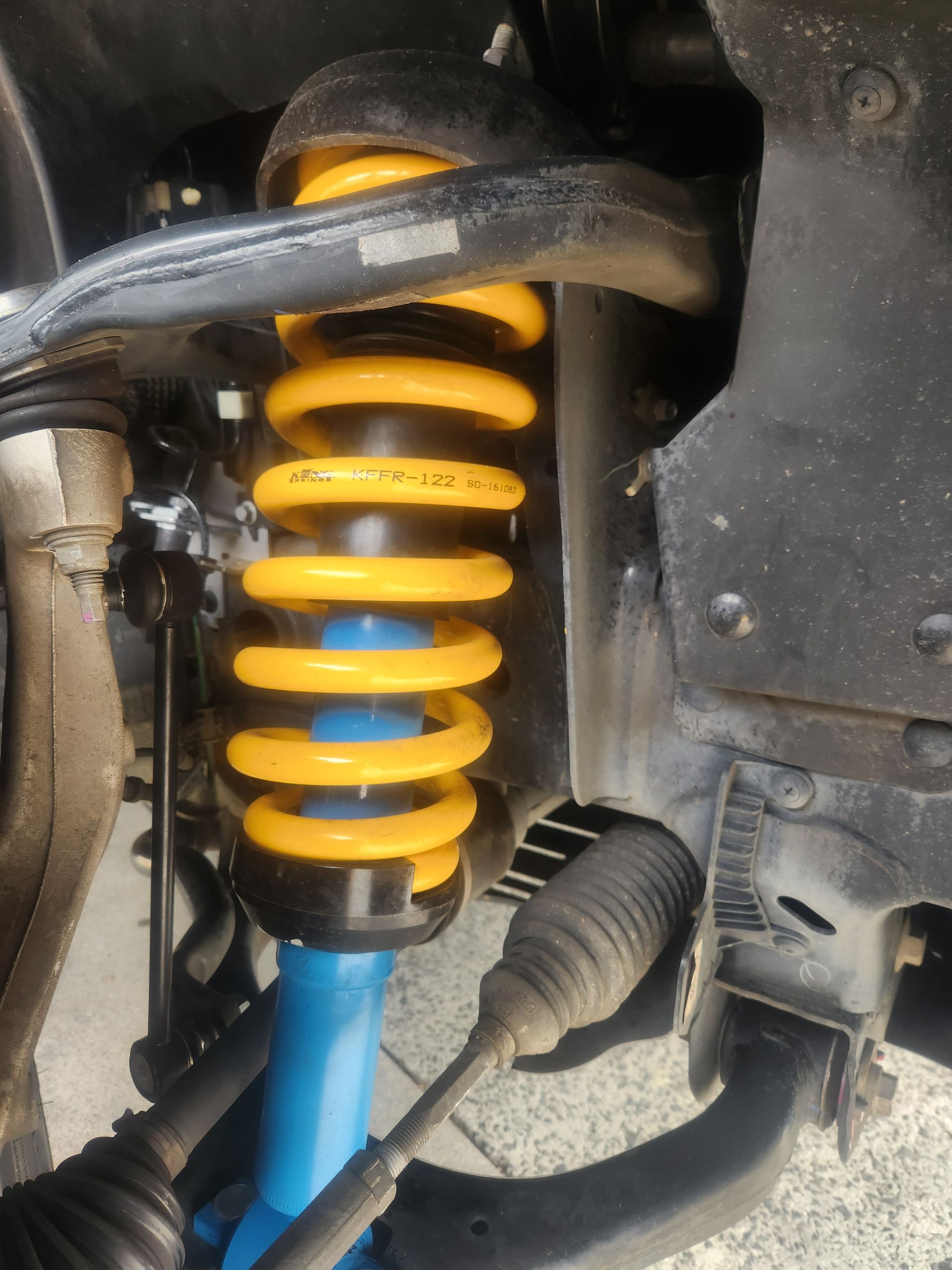 Yellow Coil Spring and Blue Shock Absorber on A Vehicle's Suspension System — Autoplus Picton in Picton, NSW