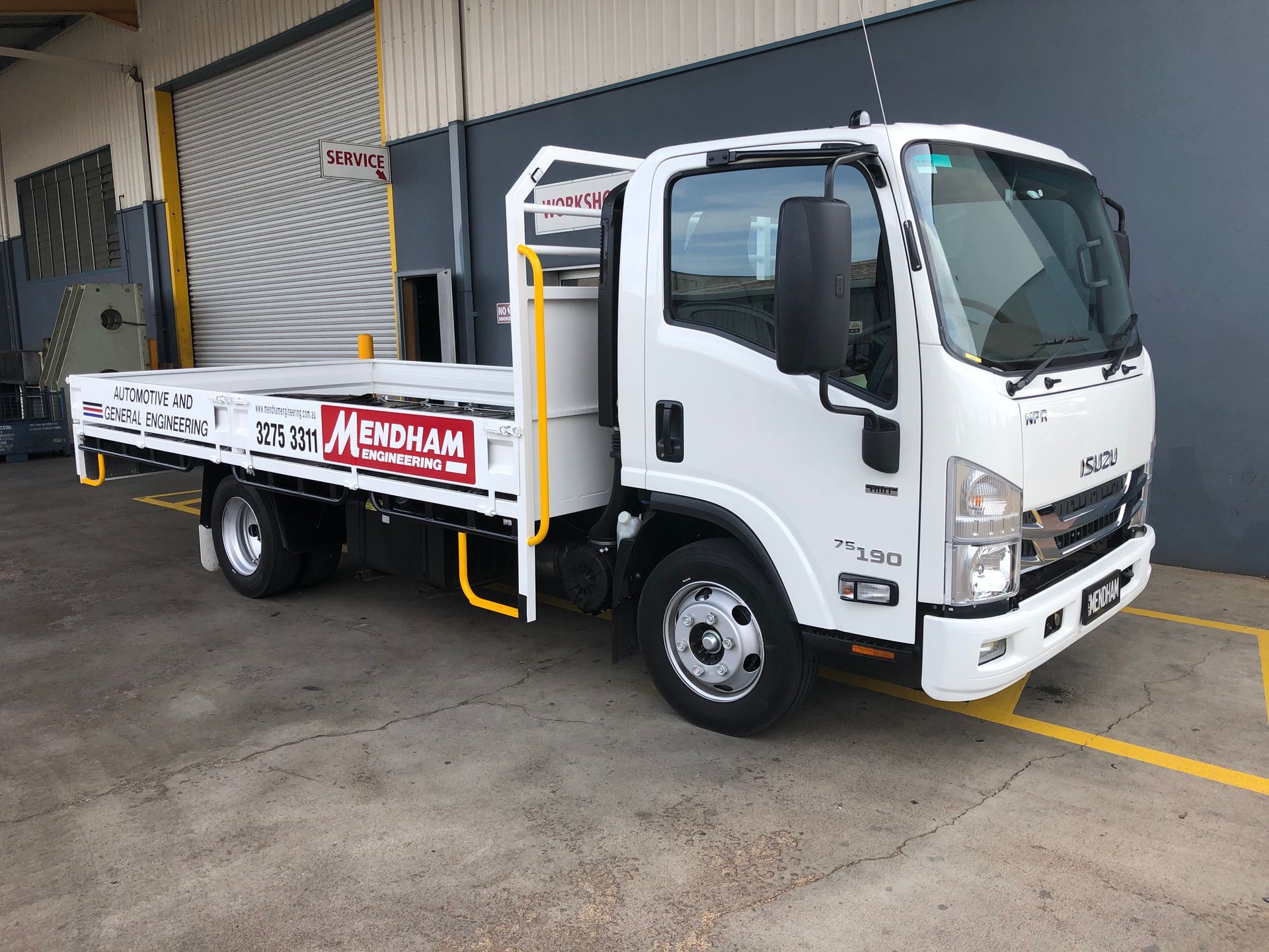 A white truck is parked in a parking lot in front of a building — Brisbane, QLD — Mendham Engineering Pty Ltdengineering