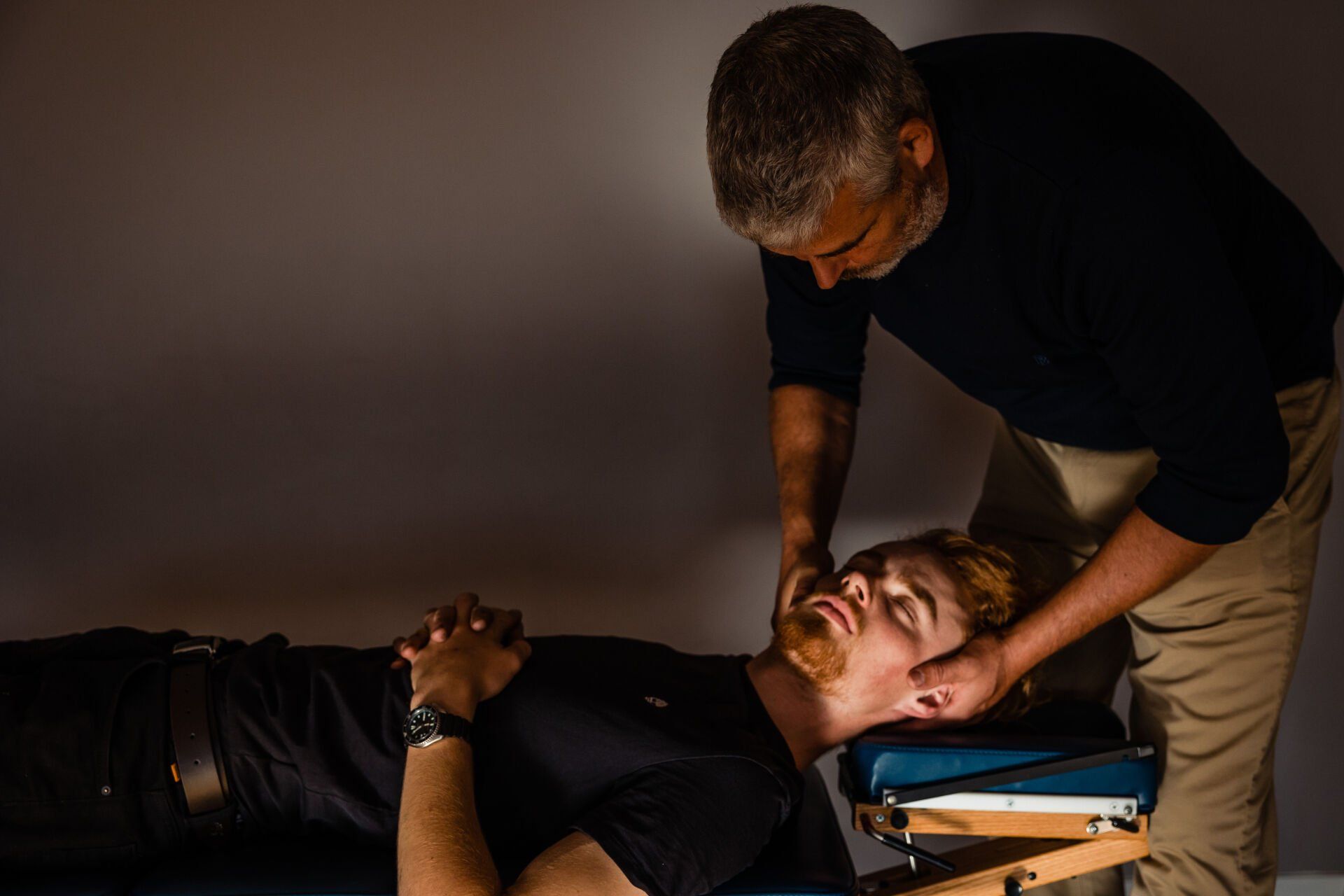 a man is giving a man a massage on a table .