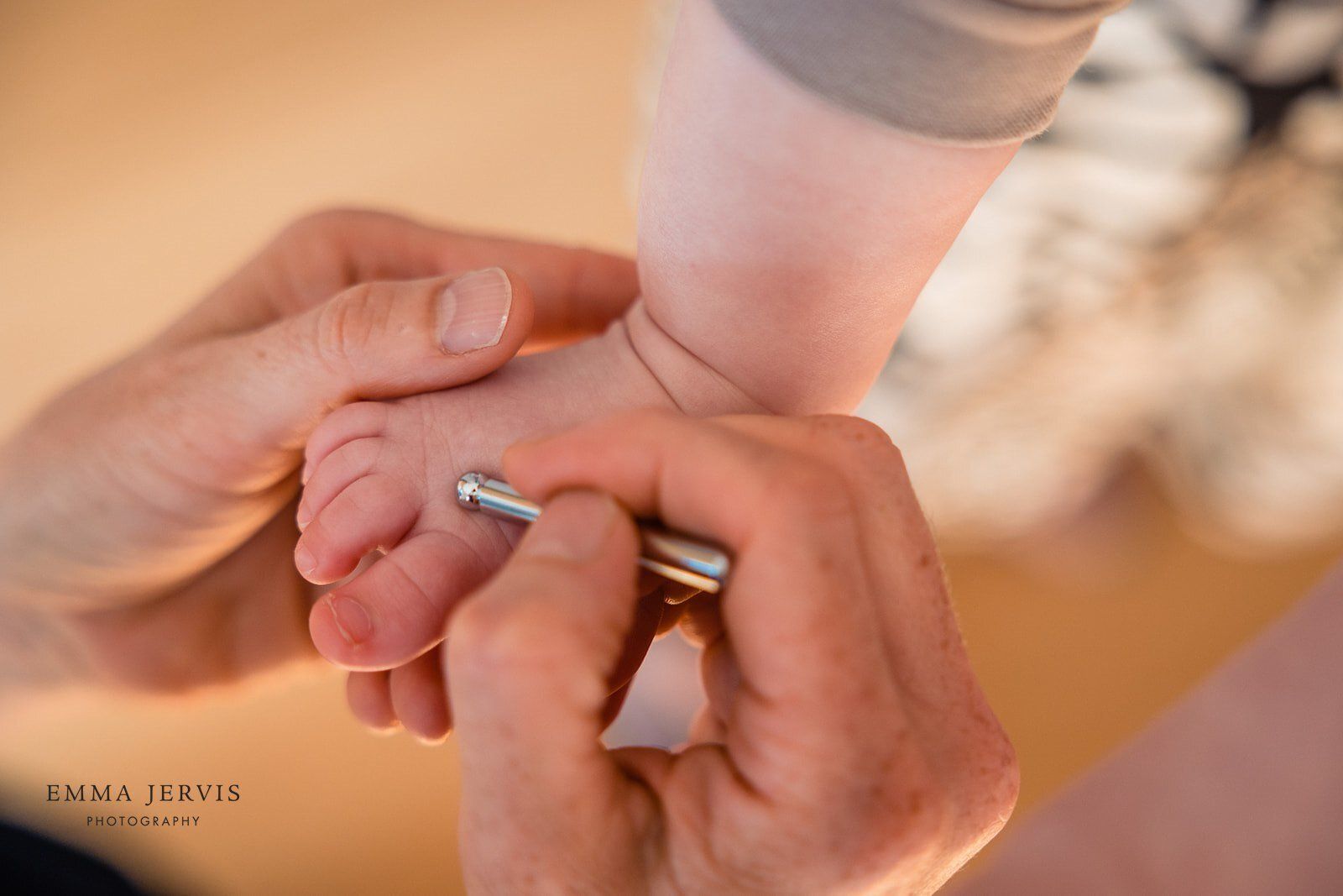 a close up of a person holding a baby 's foot .