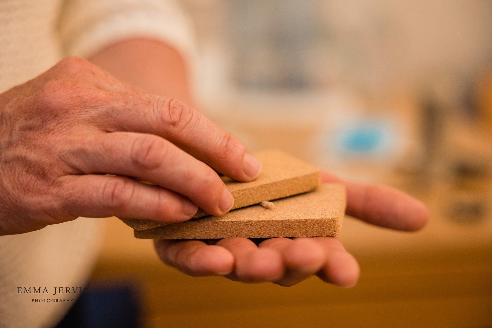 a person is holding a piece of wood in their hands .