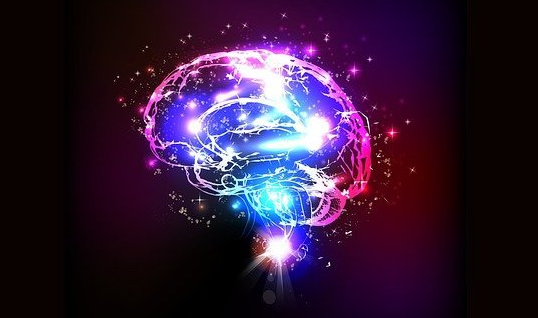 a glowing brain is surrounded by glowing lights on a dark background .