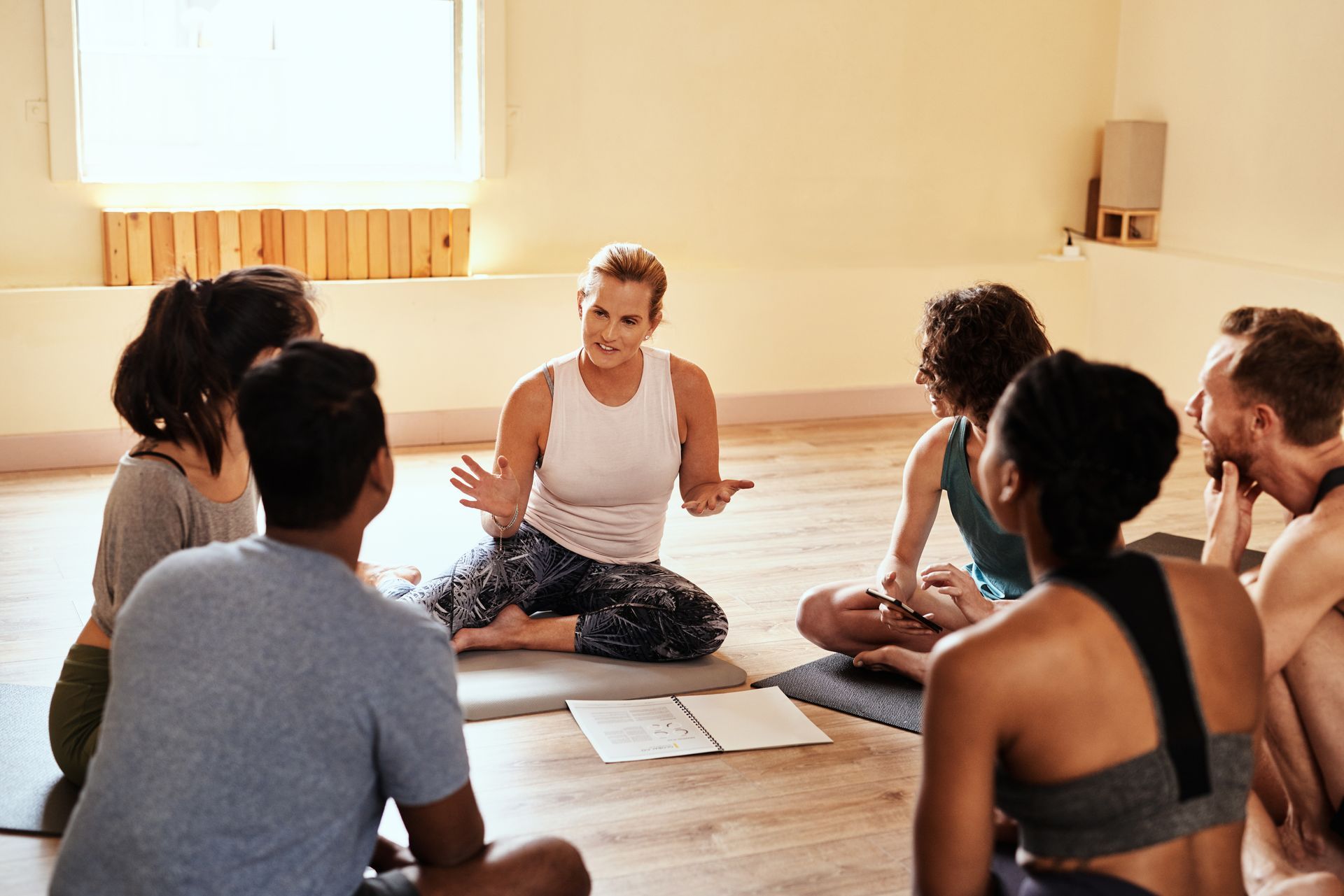 men and women chatting during yoga class