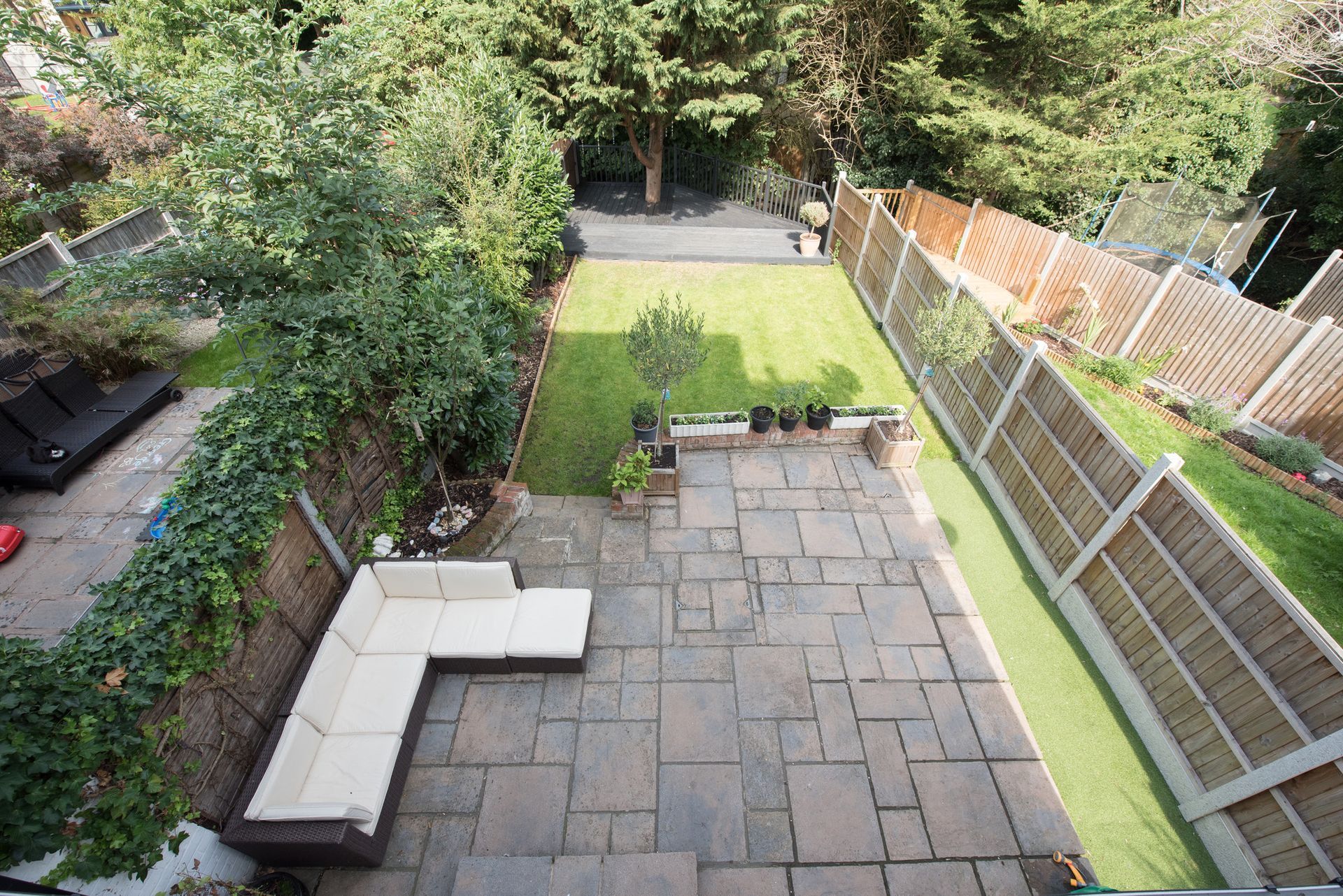 A general view of garden furniture in a back garden with patio and decking area