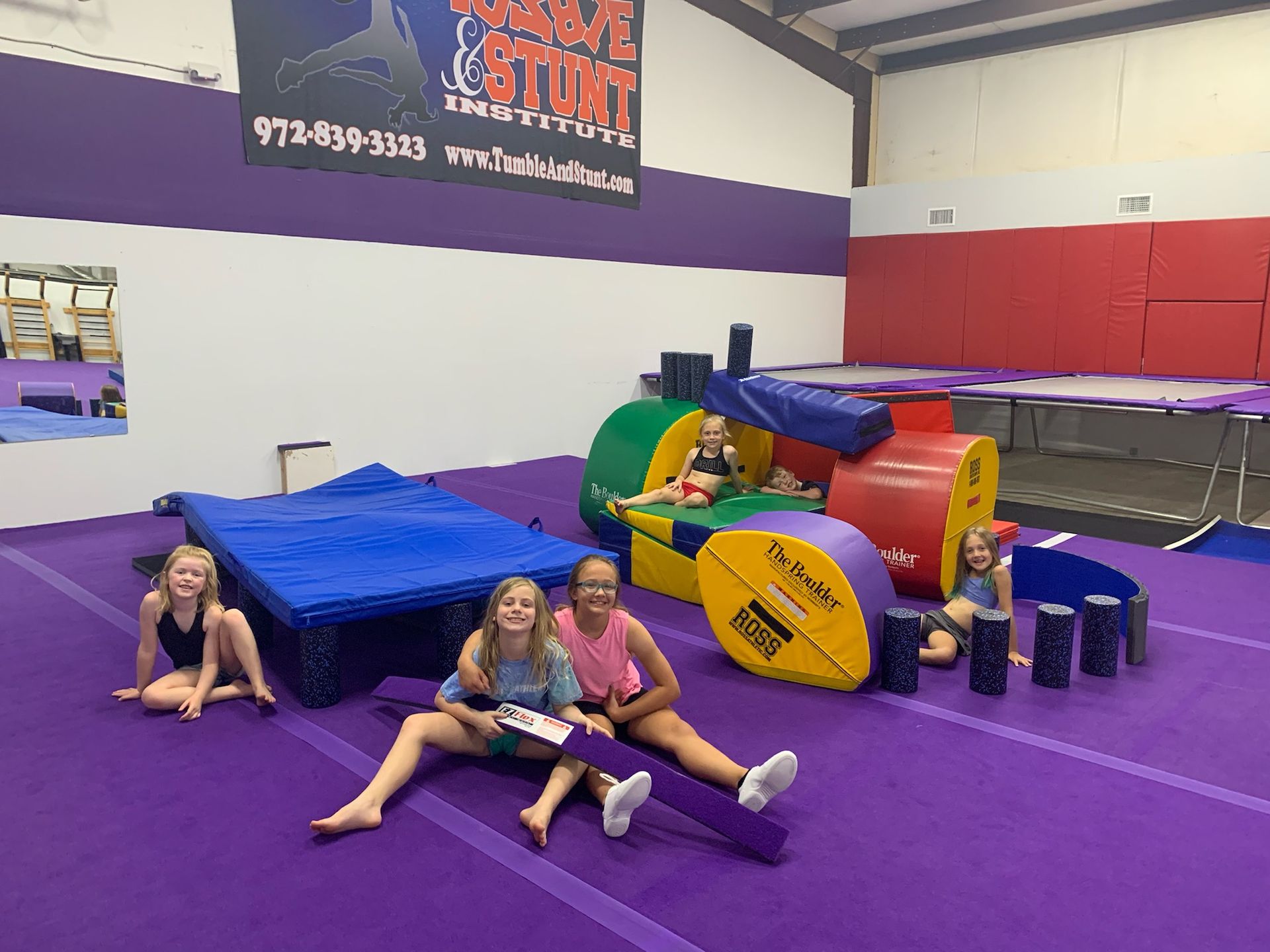 Tumble and Stunt Students in a Beginner Class with tumbling equipment