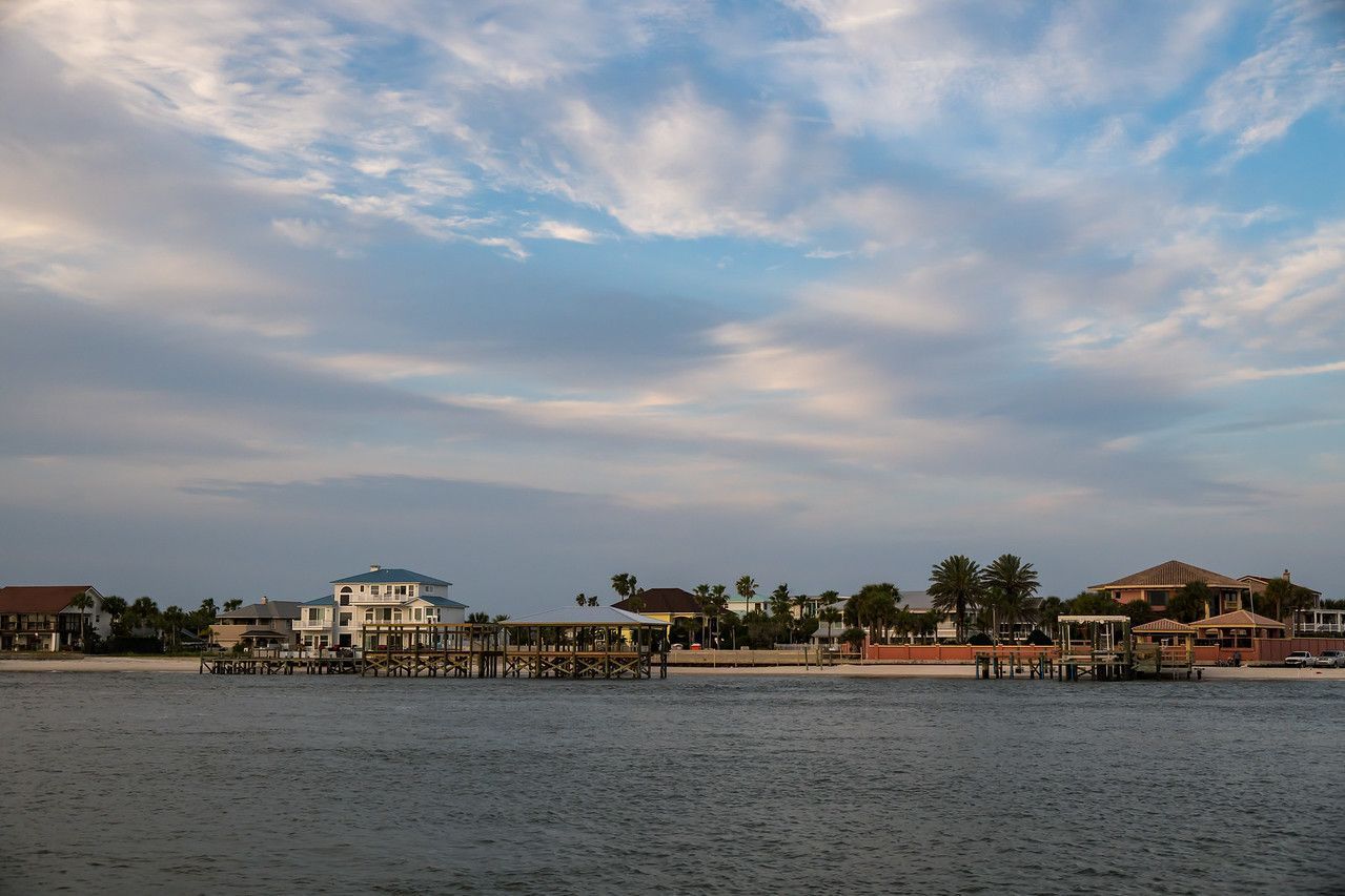 A large body of water with houses in the background