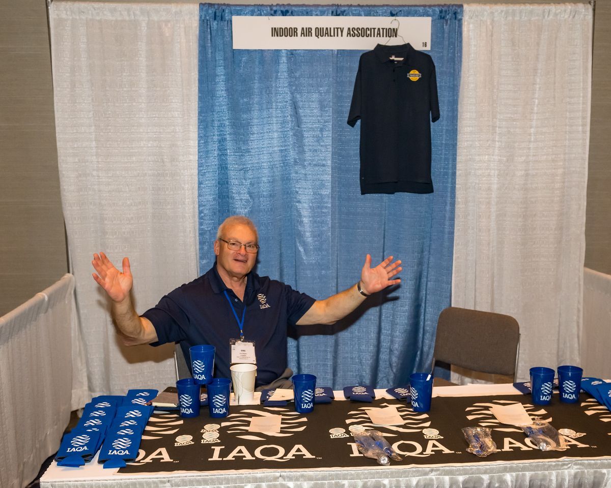 A man sitting at a table with his arms outstretched