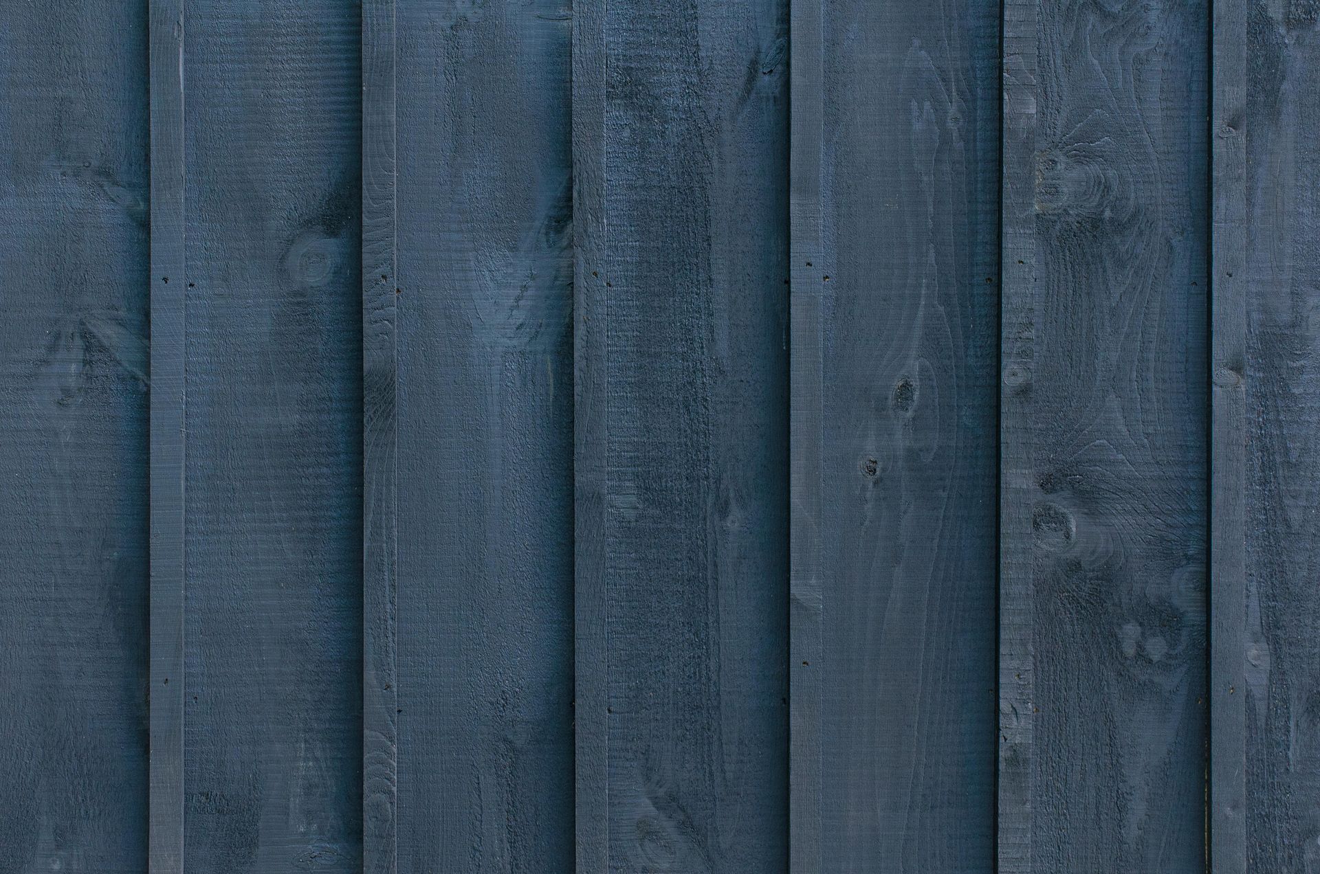 A close up of a blue wooden fence.