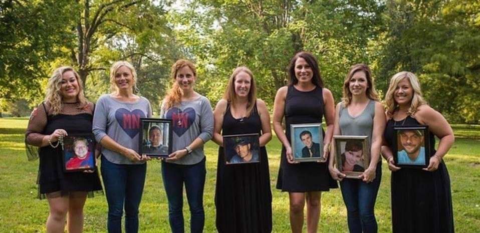 woman holding a photo of their husband