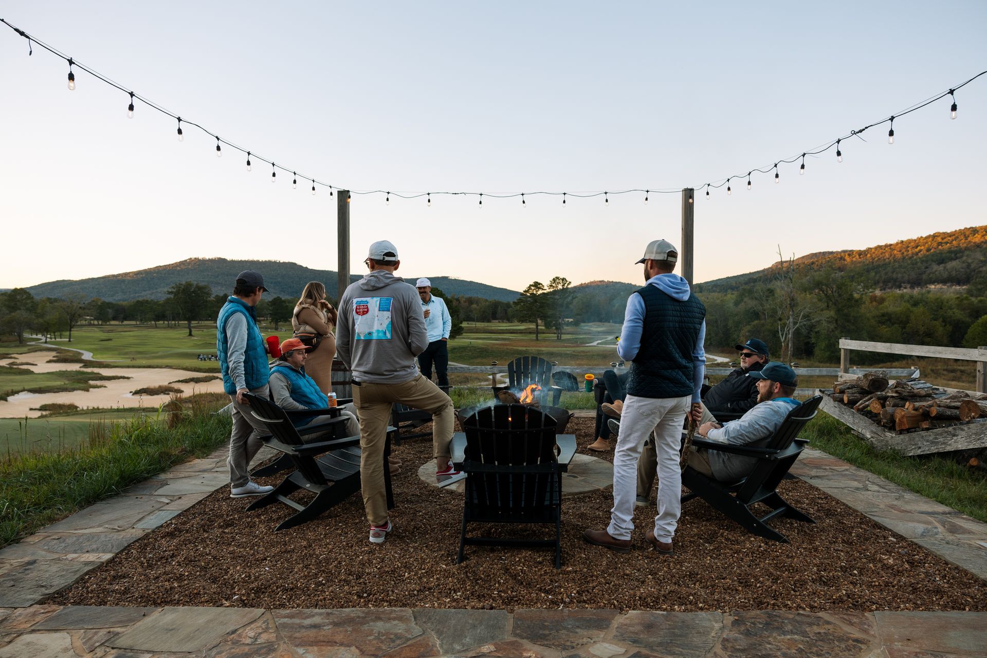 Group of friends hanging out around a fire pit