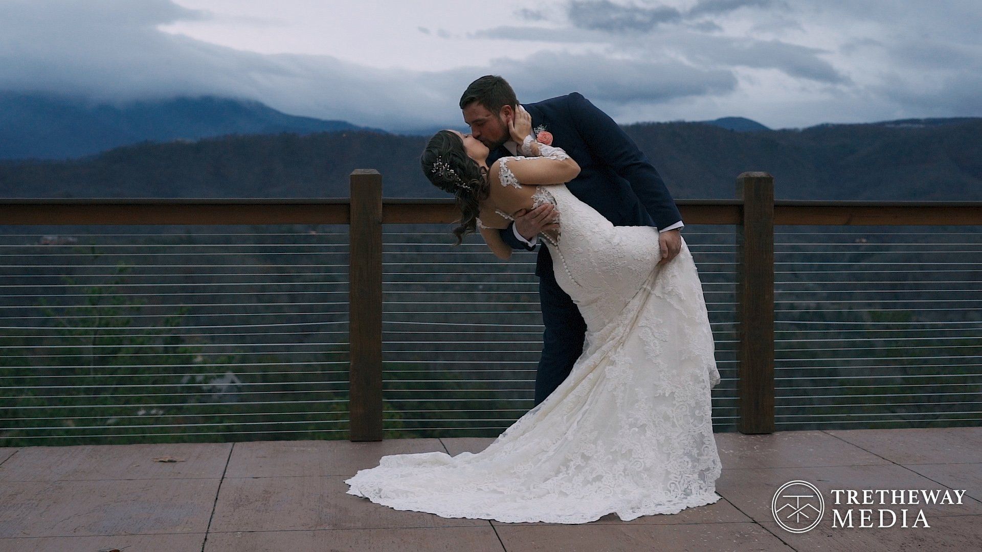 Bride and Groom kissing on the deck of the Magnolia Venue with the Smoky Mountains in the background, Knoxville Wedding Videographer