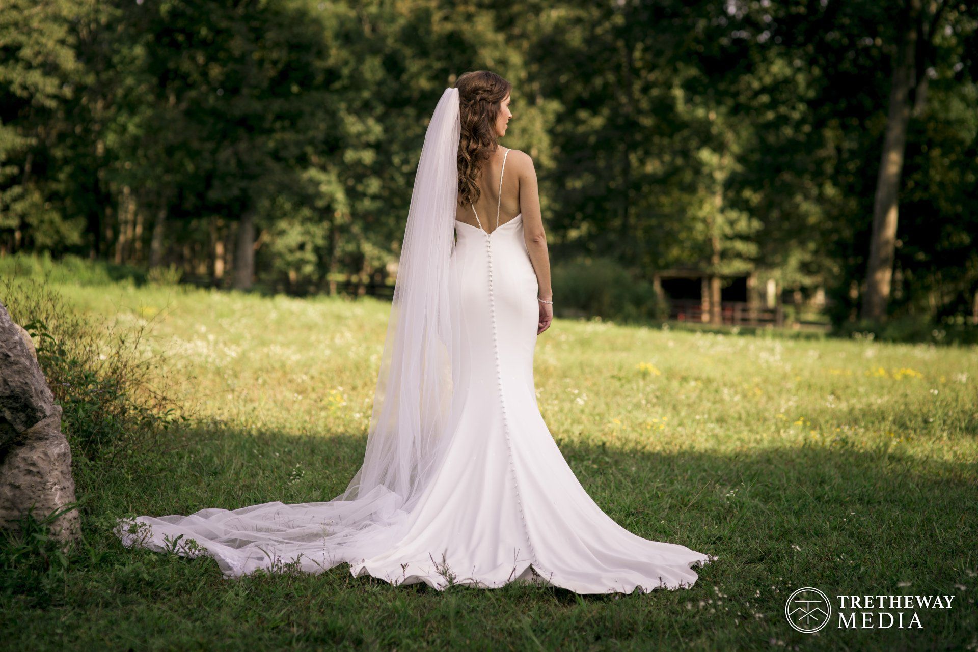Bride looking into the distance as she poses for her bridal portrait at her wedding venue near Nashville, TN, Nashville Wedding Photographer