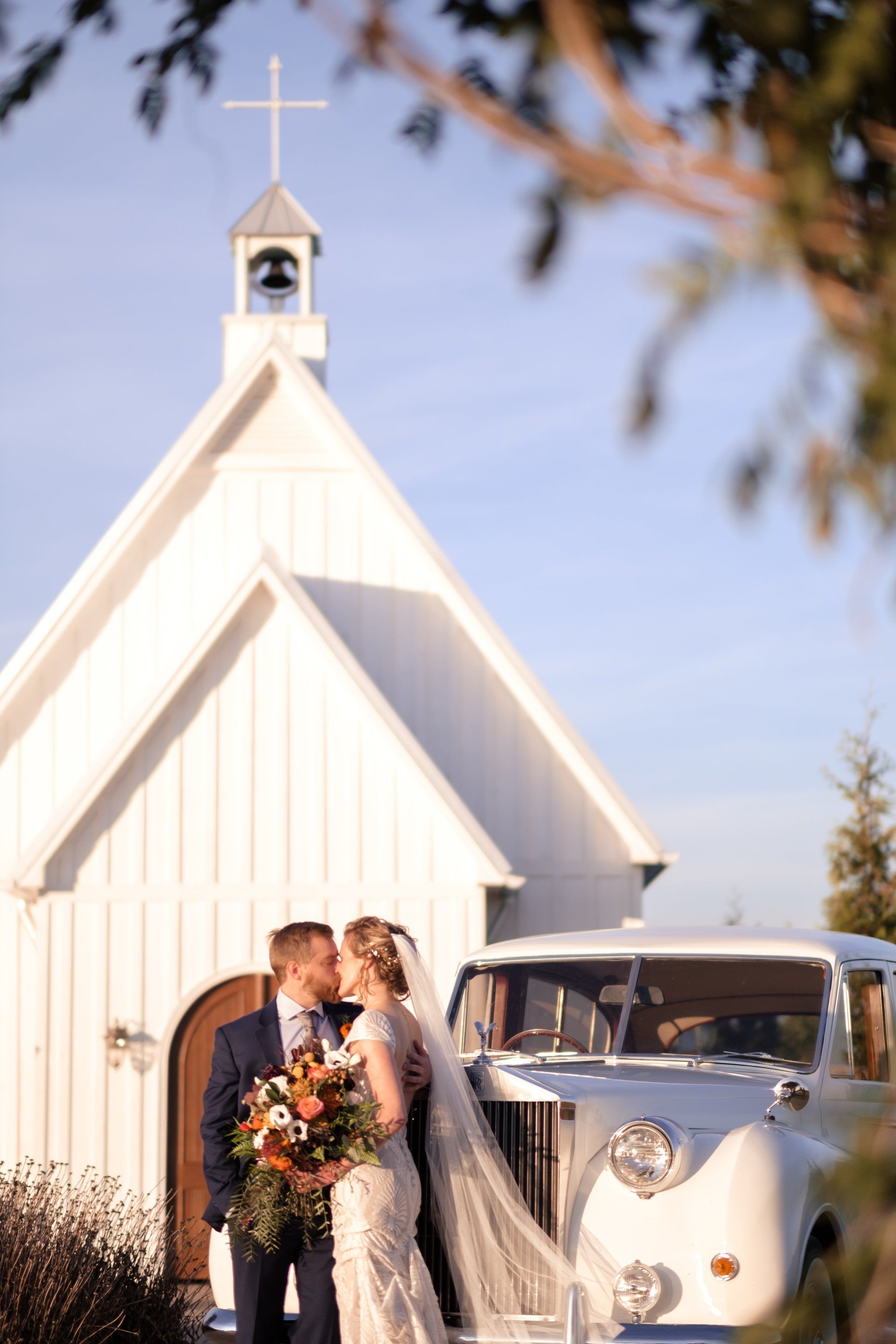 Bride and groom kissing in front of a Rolls Royce at Howe Farms near Chattanooga, TN, Chattanooga Wedding Photographer