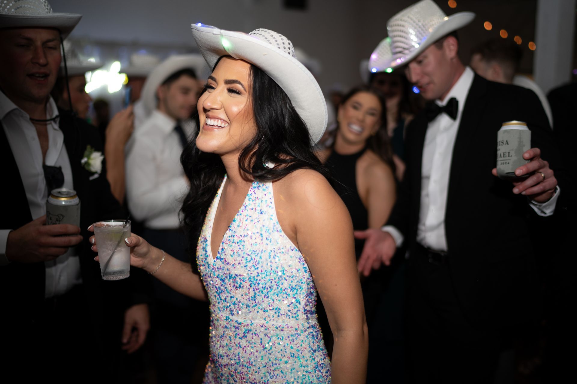 Nashville bride dancing during the reception in a sequin jumpsuit and cowboy hat