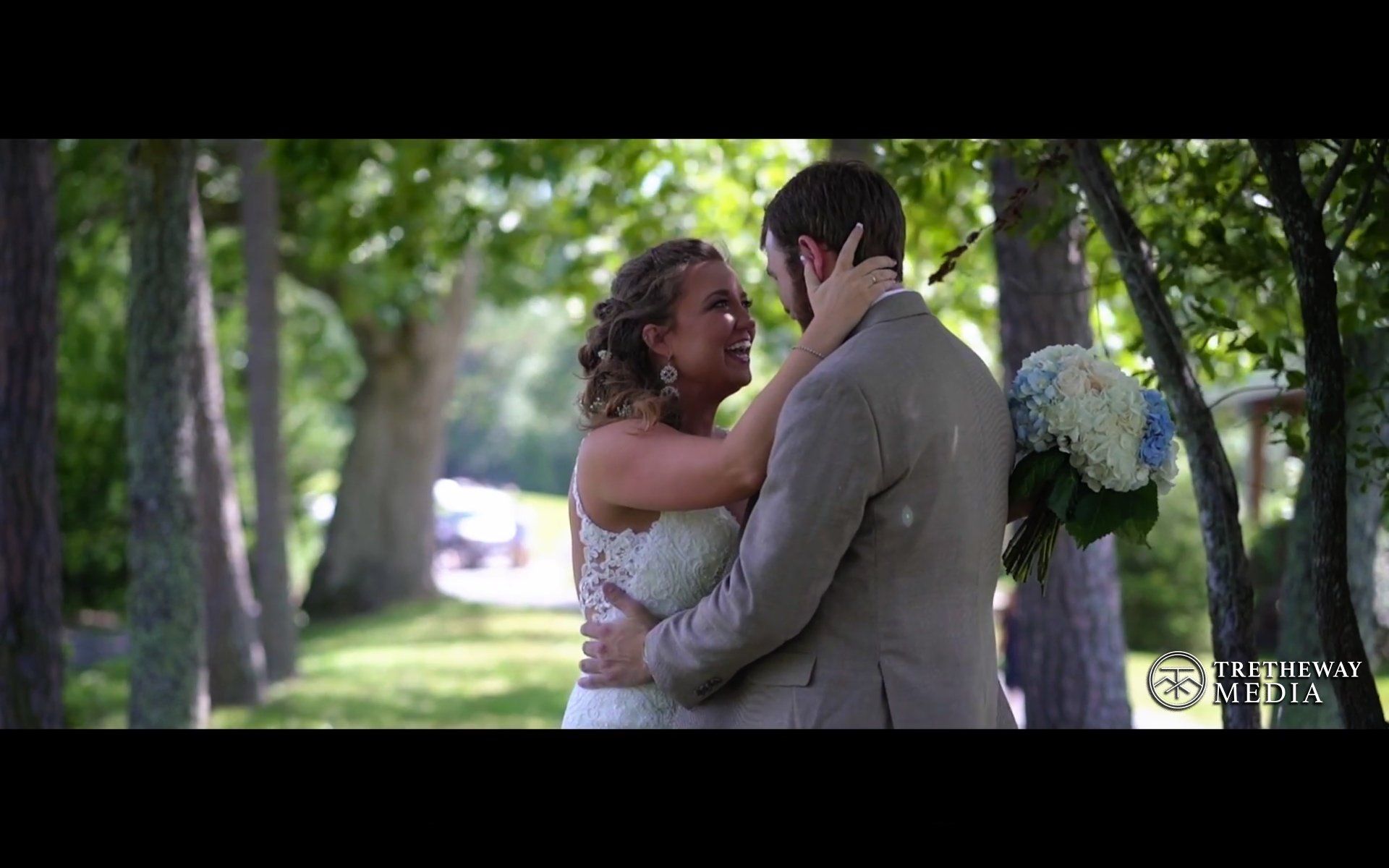 Bride laughing with her groom underneath the trees near Asheville, NC, Asheville Wedding Videographer