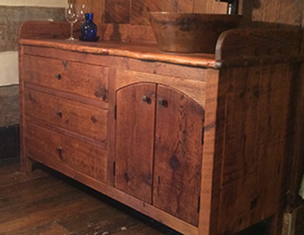 Wooden rustic vanity with drawers, doors, and a wooden bowl