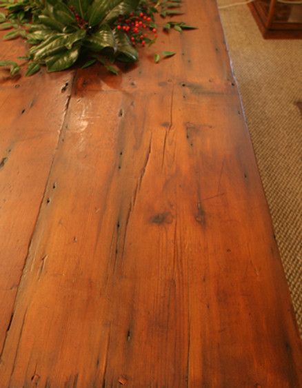 Close-up of a long, rustic wooden table