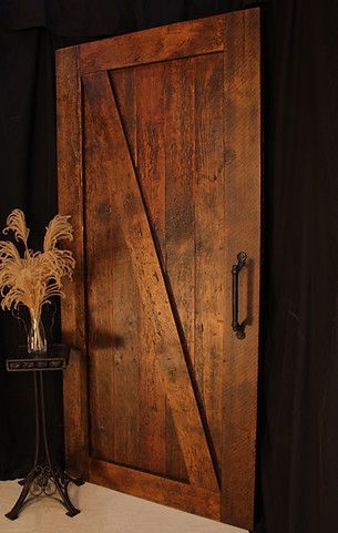 Rustic wooden barn door with diagonal brace