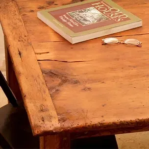 Wooden table with book, glasses; aged appearance