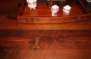 Wooden table with decorative tray and figurines