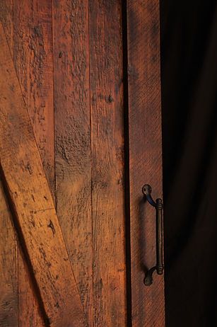 Rustic wooden barn door with black handle