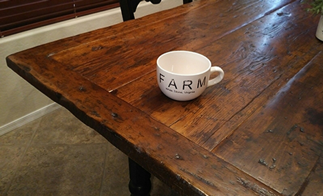 Wooden farmhouse table with mug