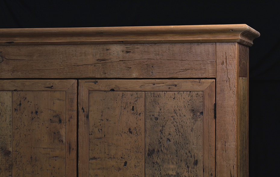 Wooden cabinet with a distressed, weathered finish
