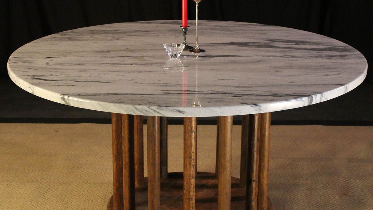 Round table with a marble top and wooden base
