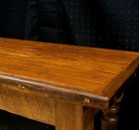 Wooden bench with a varnished surface, showing grain and joinery details