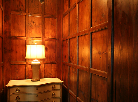 Wooden paneled room with a lamp