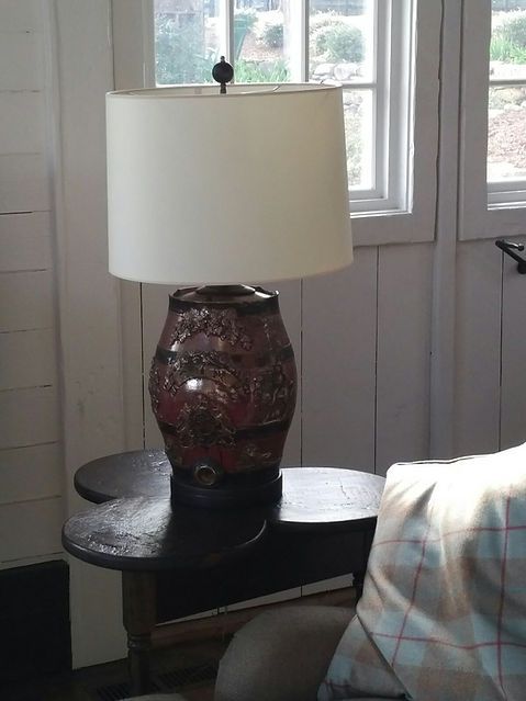 Lamp on dark table, next to window